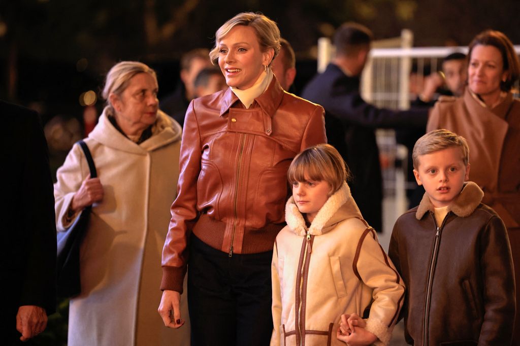 Princess Charlene of Monaco stands next to her children Princess Gabriella and Prince's Jacques of Monaco as they attend the inauguration of the Christmas village