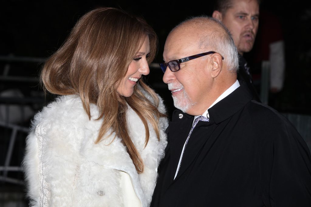 Celine Dion smiling at her husband Rene in a fluffy jacket