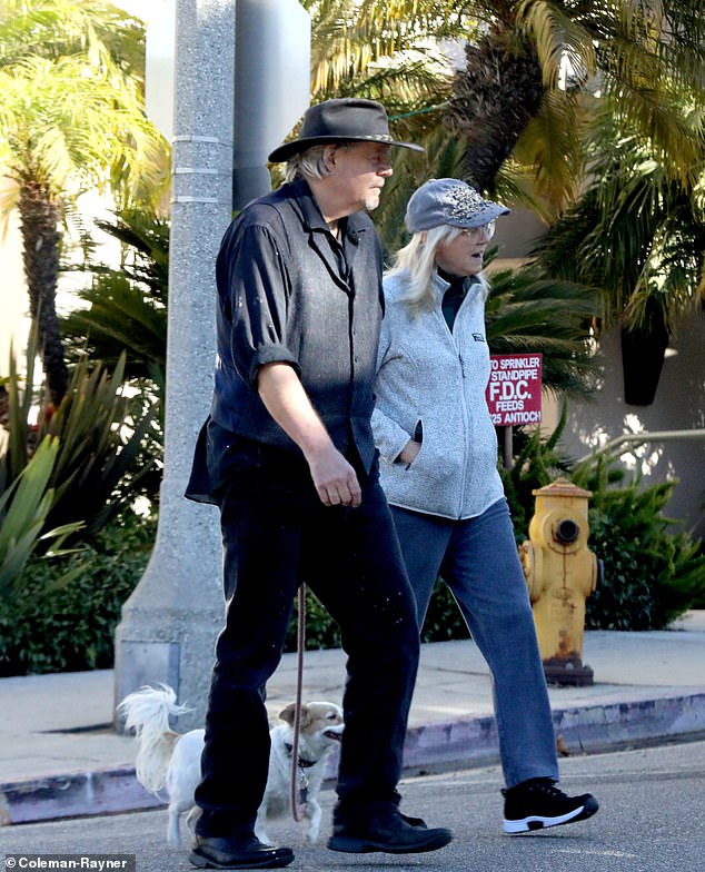 Long and her unknown male friend walking a small, fluffy dog in the Los Angeles neighborhood