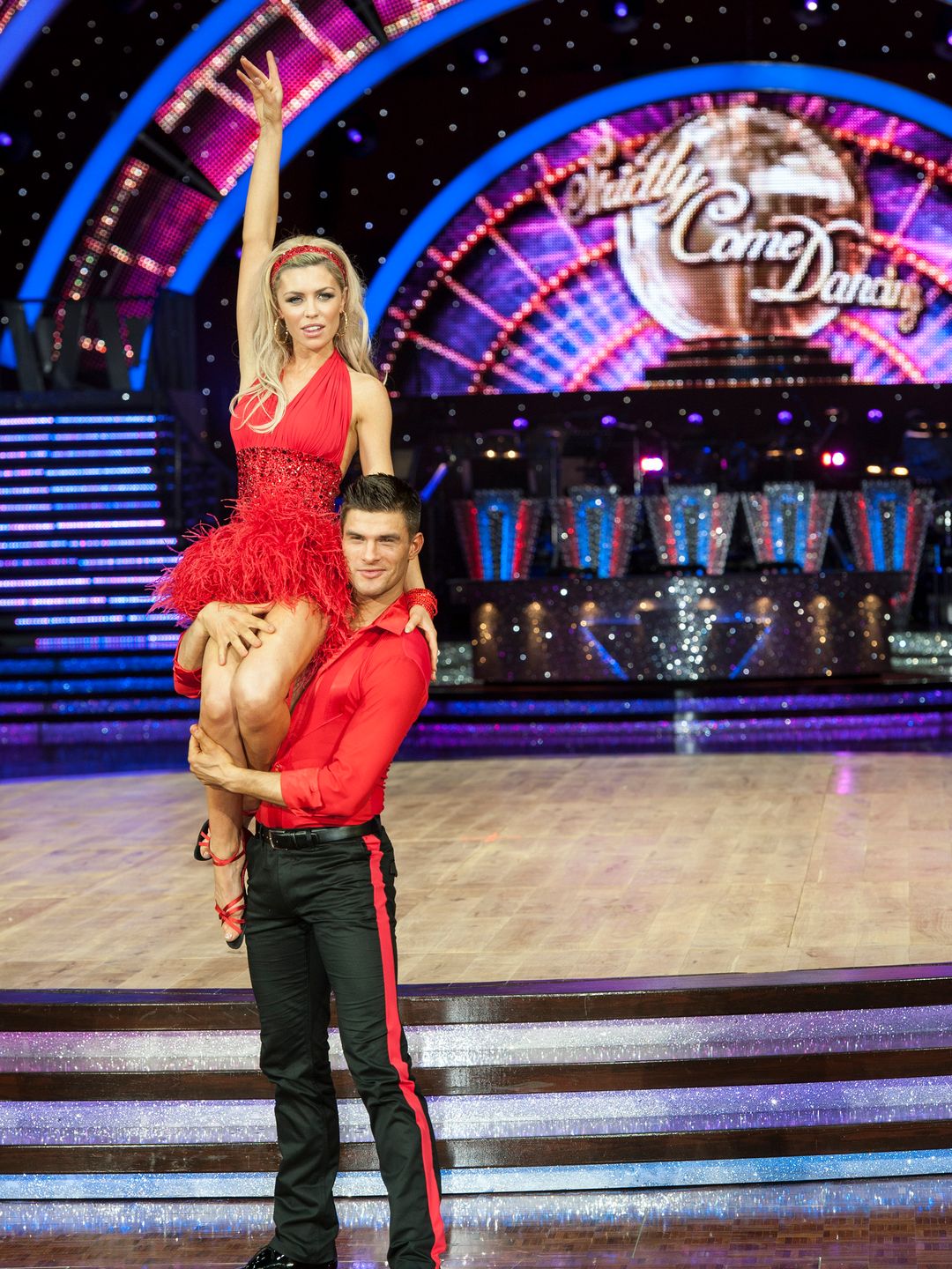 Aljaz Skorjanec holding Abbey Clancy up