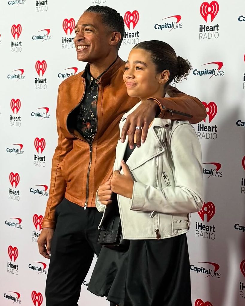 TJ Holmes wears a ring as he poses with his daughter Sabine