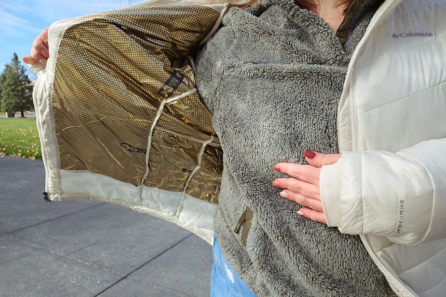 A person shows the inside of the Columbia Women's Mid Insulated Hooded Jacket