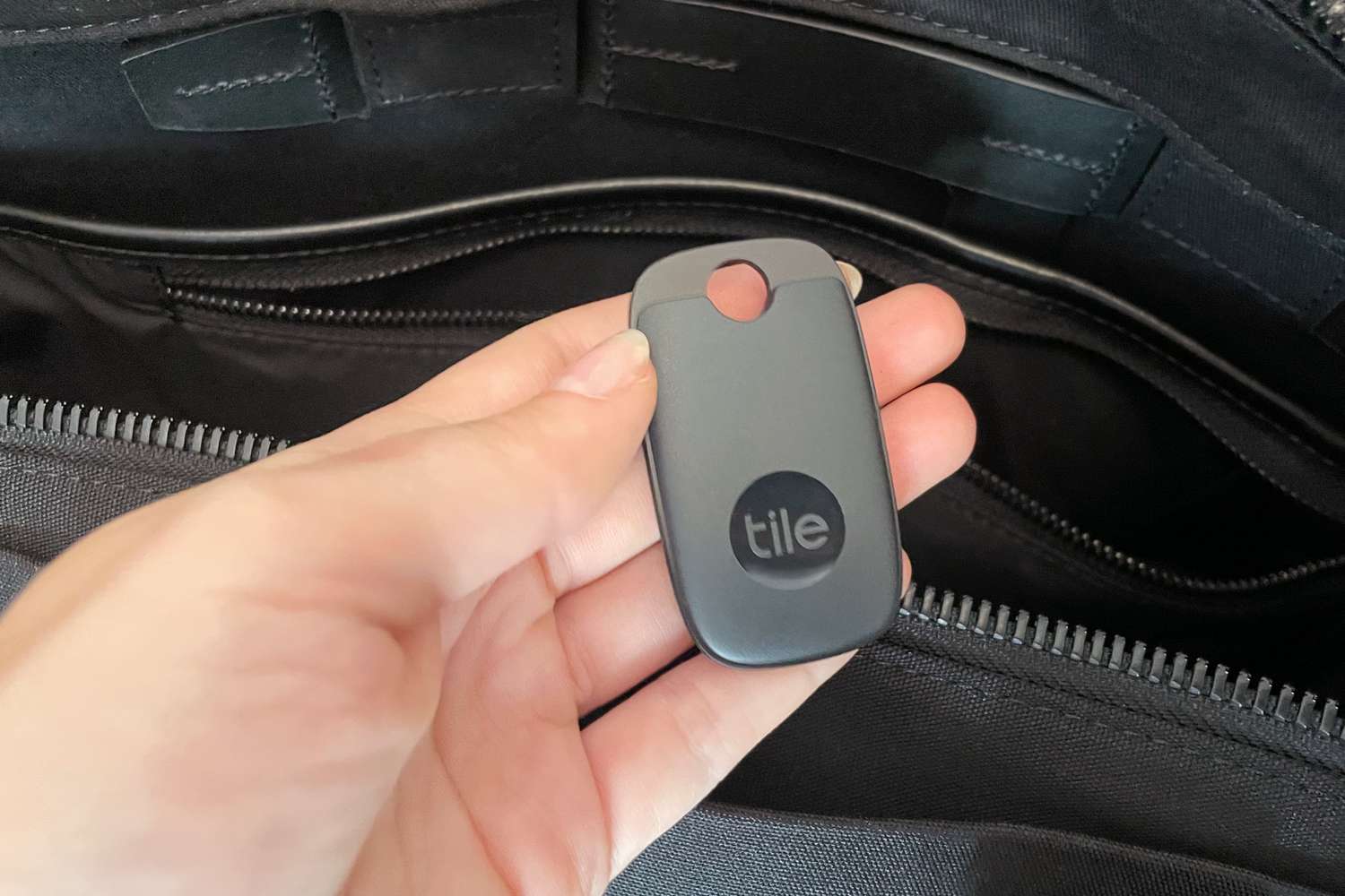 A person holding the Tile Pro Bluetooth Tracker