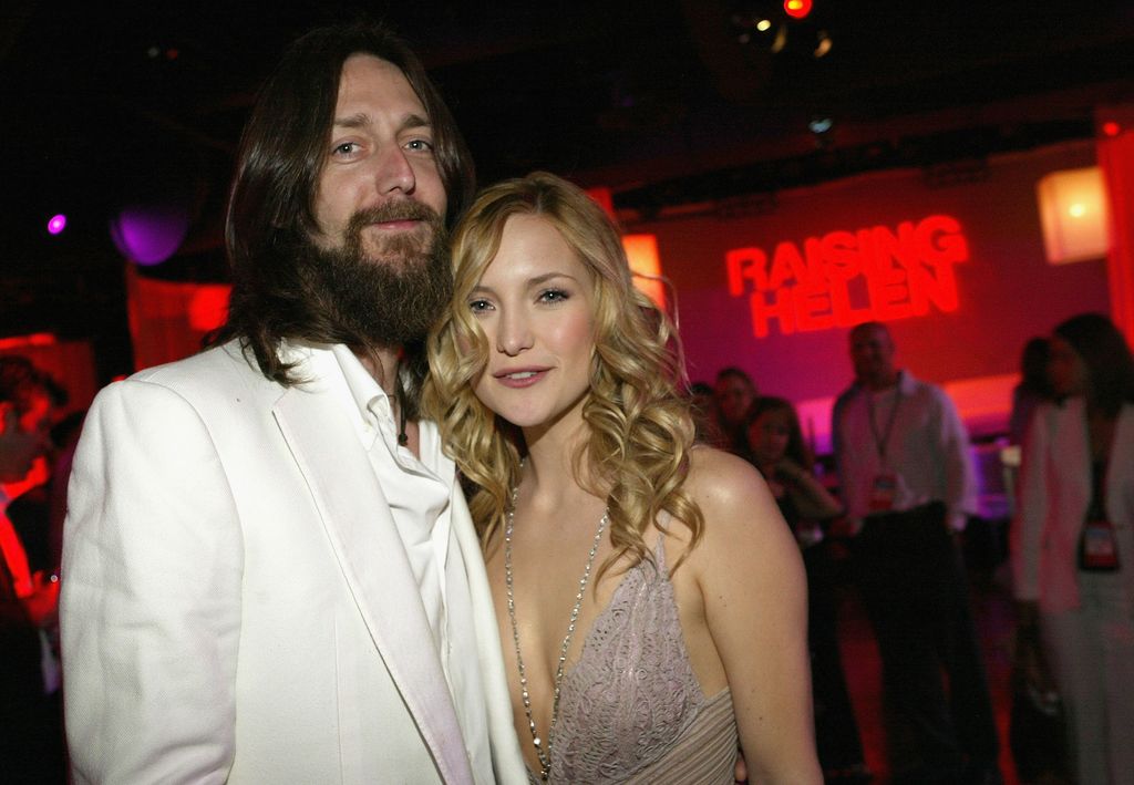 Actress Kate Hudson and husband, musician Chris Robinson, pose as they attend the film premiere after party for the romantic comedy "Raising Helen" at the Highlands on May 26, 2004 in Hollywood, California.