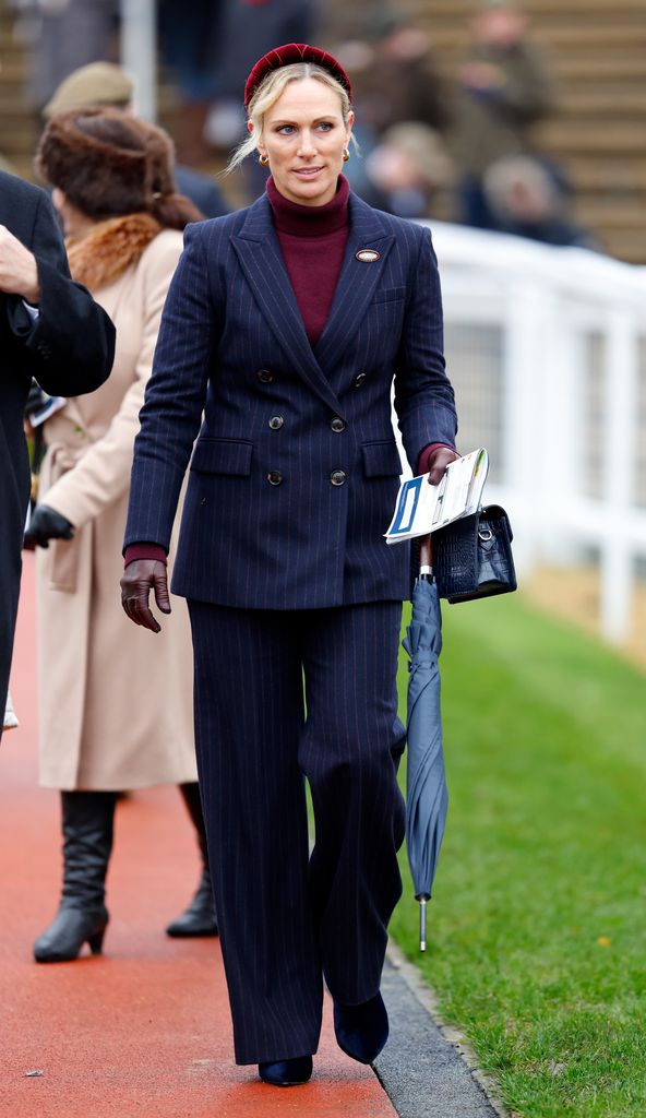 Zara Tindall walking in navy suit