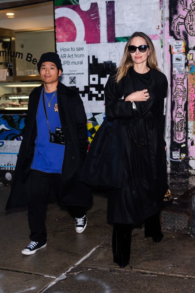 Pax Jolie-Pitt (L) and Angelina Jolie are seen in the East Village on December 28, 2023 in New York City