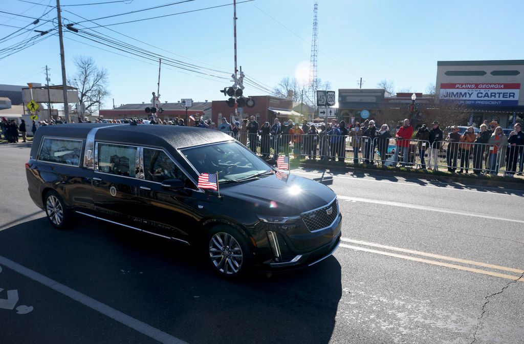 The hearse carrying President Jimmy Carter passes near the main street of Carter's hometown on January 04, 2025, in Plains, Georgia