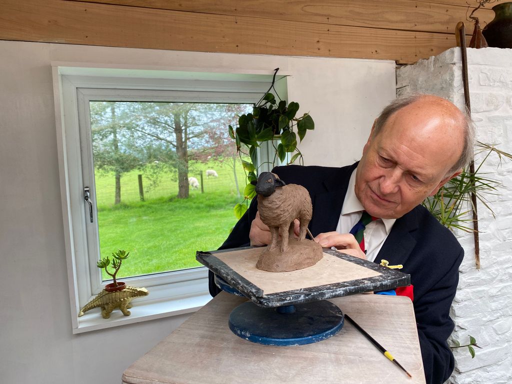 Charlie Ross holding a statuette of a sheep