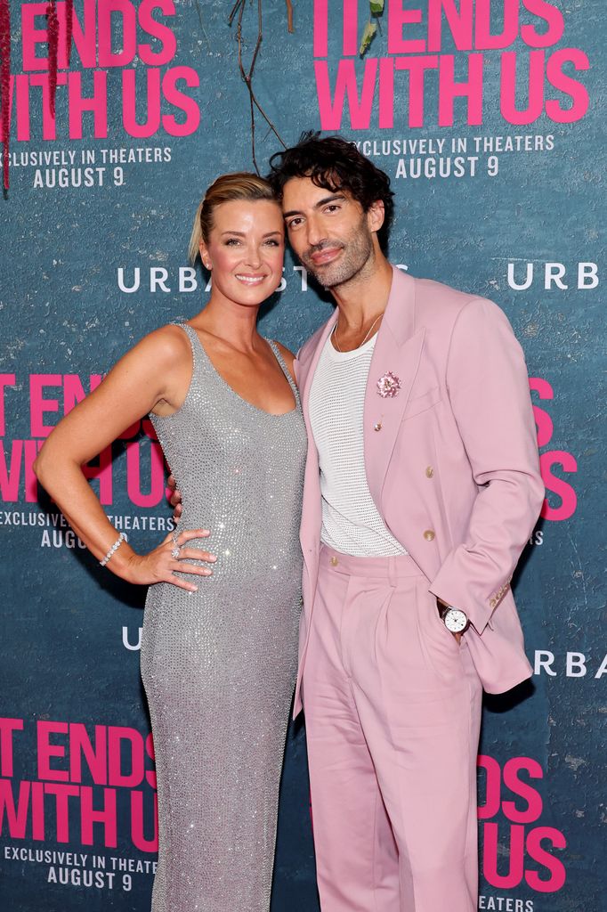 justin baldoni in pink suit with wife emily in silver dress on red carpet