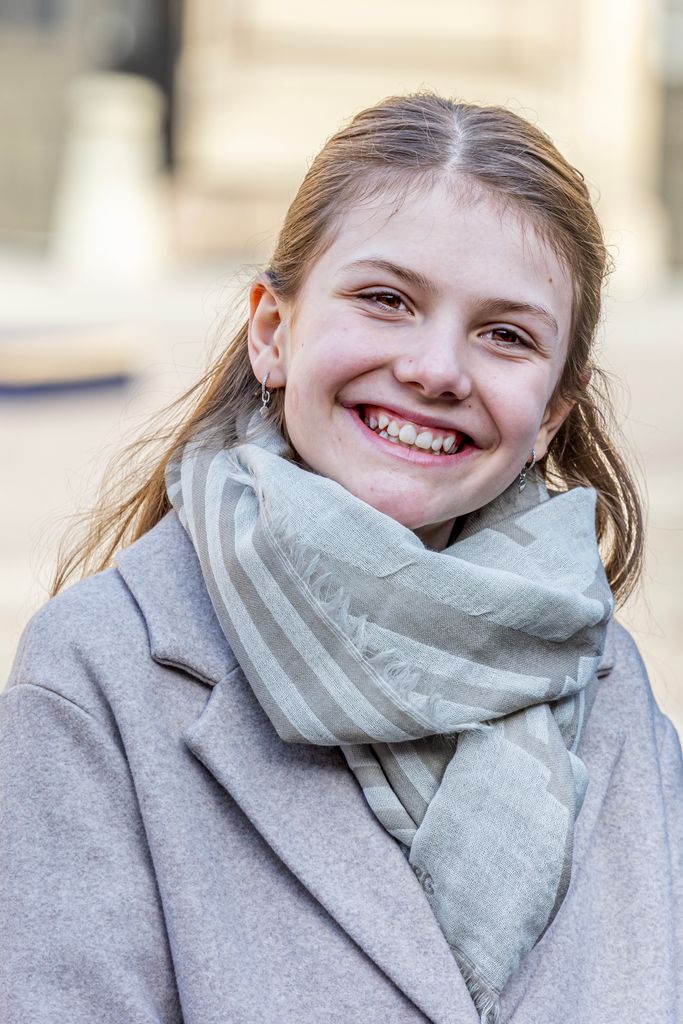 Princess Estelle smiling in grey scarf and coat