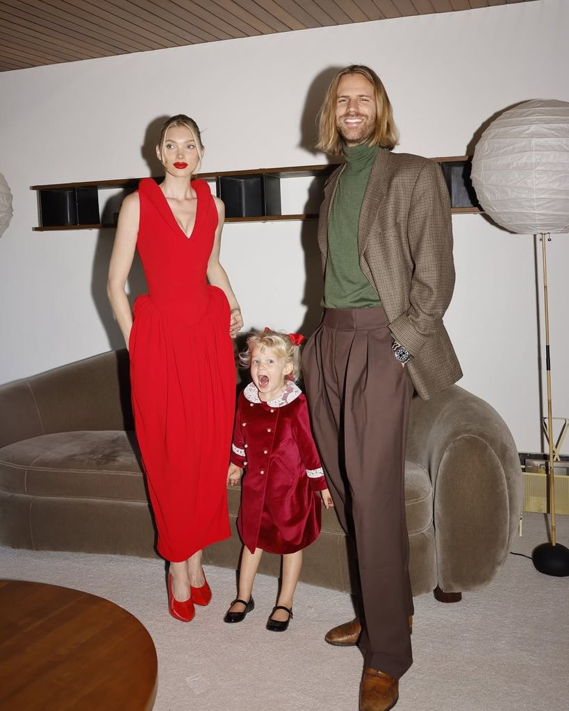 Elsa Hosk's family wearing coordinated red, green, and velvet outfits. The playful yet polished look captured holiday cheer.