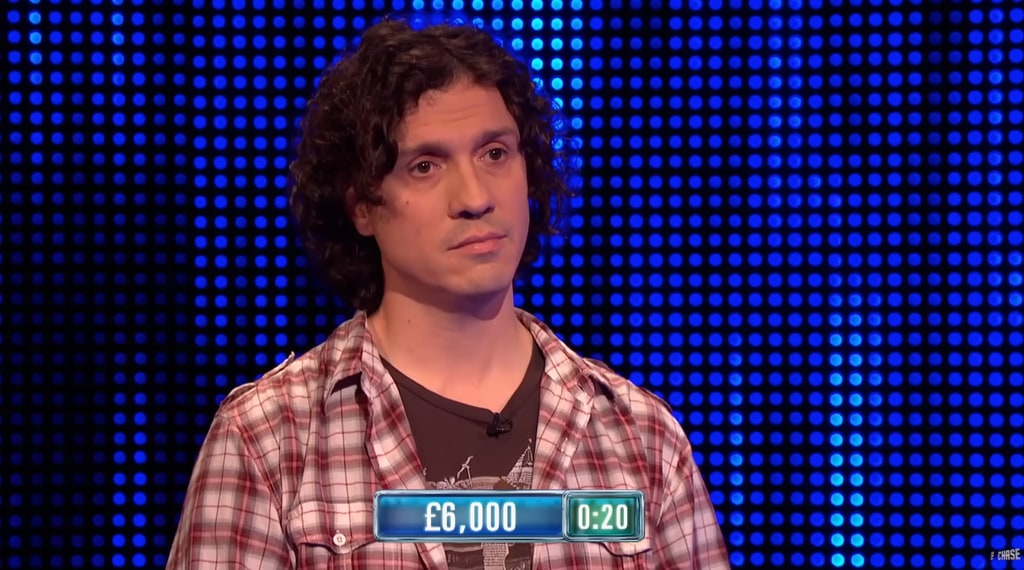 Dark-haired man in red shirt