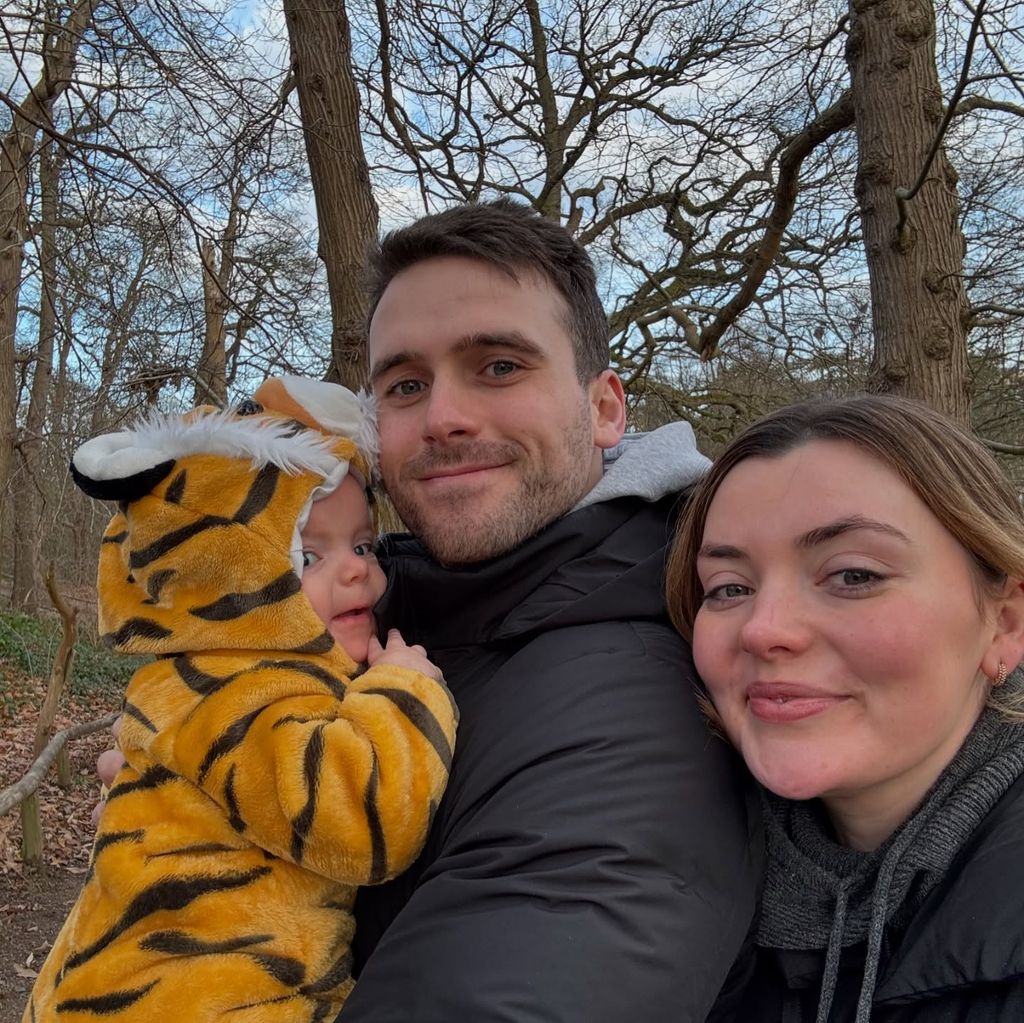 couple walking outside with baby daughter