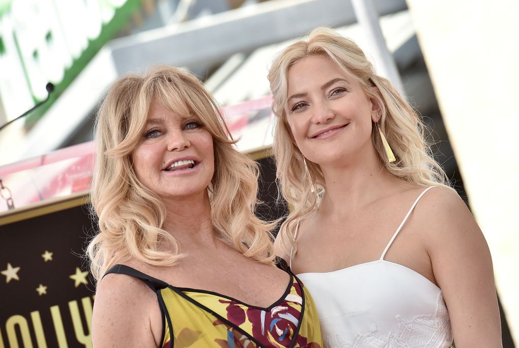 Goldie Hawn and Kate Hudson smiling on the red carpet