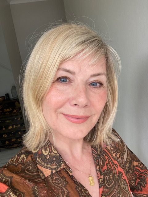 Woman taking a selfie in a patterned shirt