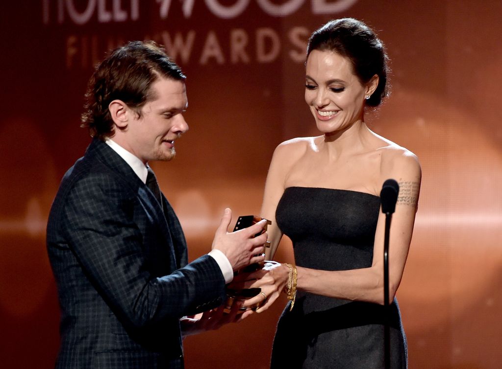 HOLLYWOOD, CA - NOVEMBER 14:  Actor Jack O'Connell accepts the New Hollywood Award for 'Unbroken' from actress Angelina Jolie onstage during the 18th Annual Hollywood Film Awards at The Palladium on November 14, 2014 in Hollywood, California.  (Photo by Kevin Winter/Getty Images)