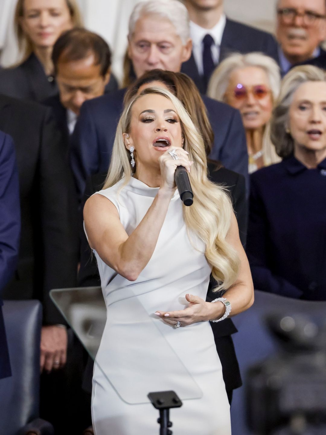 Country singerCarrie Underwood performs 'America the Beautiful' as former US President Joe Biden looks on during US President Donald Trump's inauguration ceremony