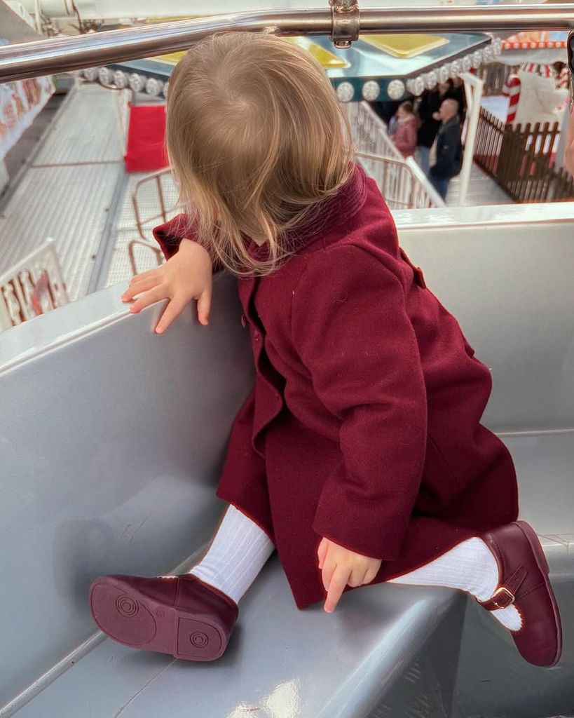 Lady Kitty Spencer's daughter Athena  in a red coat and shoes