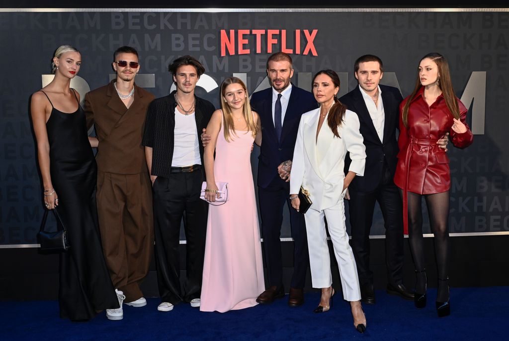 Mia Regan standing with Romeo Beckham, Cruz Beckham, Harper Beckham, David Beckham, Victoria Beckham, Brooklyn Beckham and Nicola Peltz