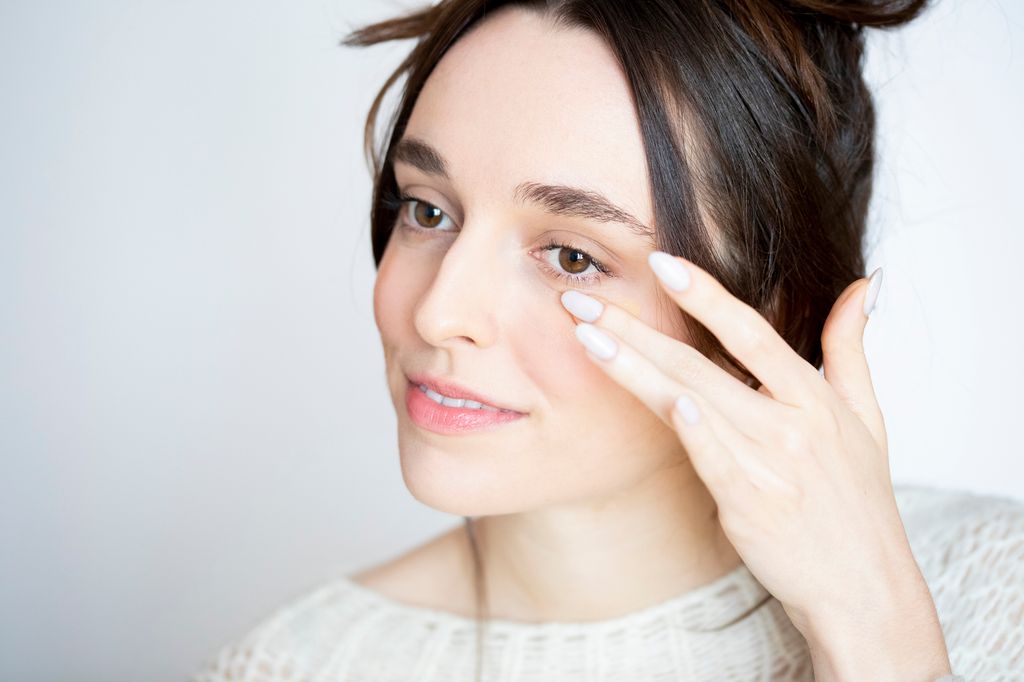 Woman applying cream products