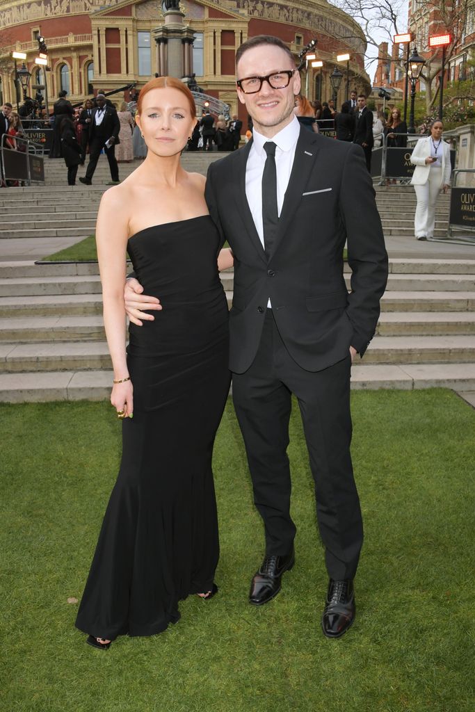 Stacey Dooley in black dress stood with Kevin Clifton in a suit