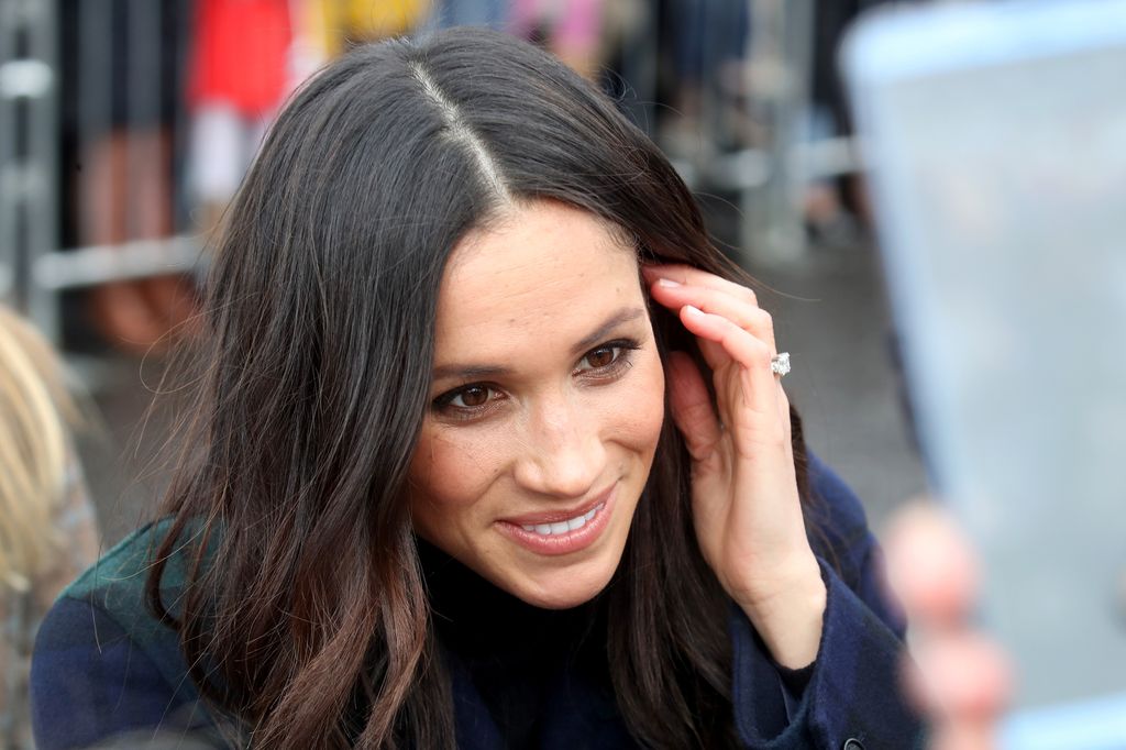 Meghan Markle pushing her hair behind her ear