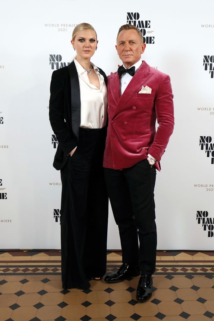 Daniel Craig and Ella Loudon, wearing Brunello Cuccinelli and Faberge at the World Premiere of "NO TIME TO DIE" at the Royal Albert Hall on September 28, 2021 in London, England