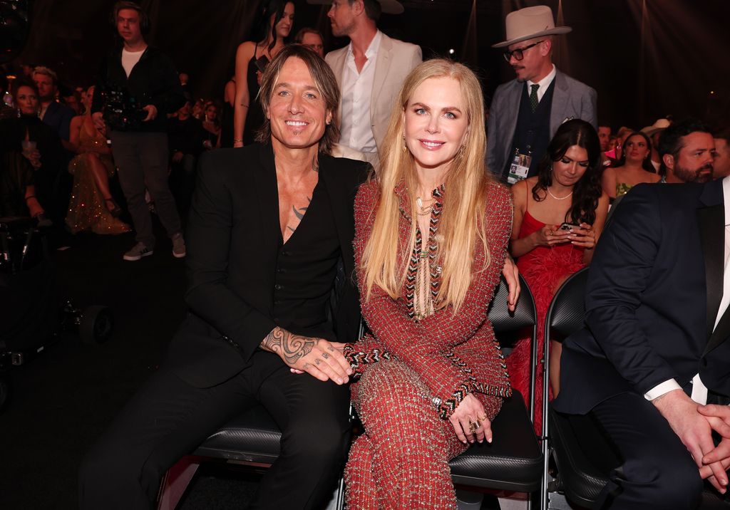 Keith Urban and Nicole Kidman sat smiling at the 58th Academy of Country Music Awards