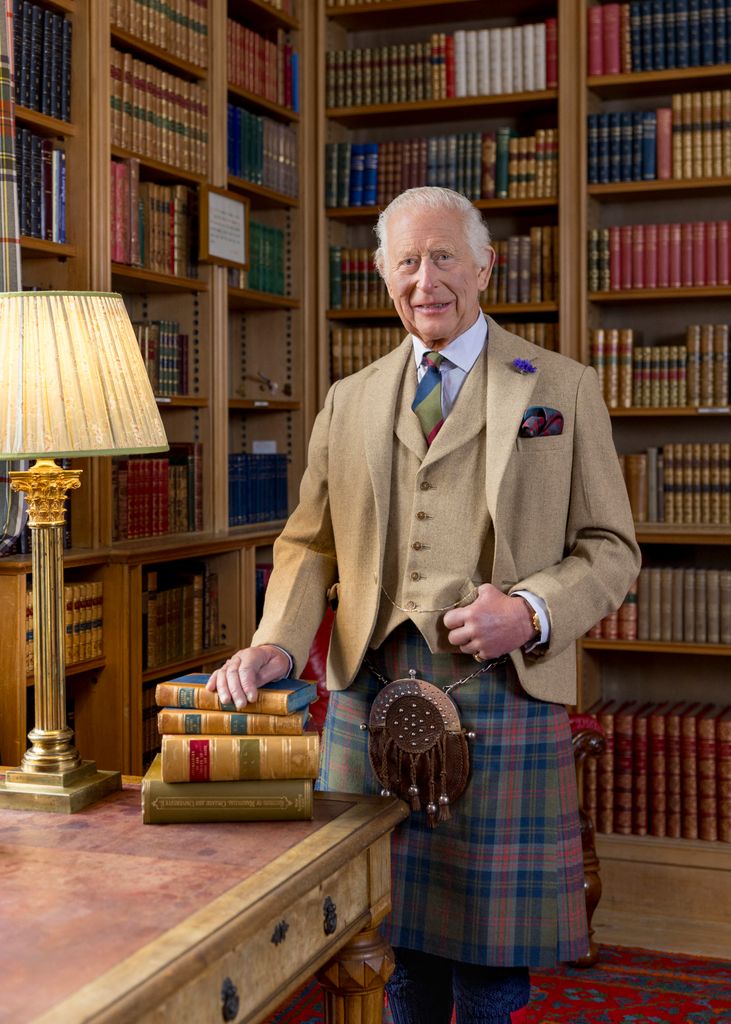 king charles posing in library wearing kilt 