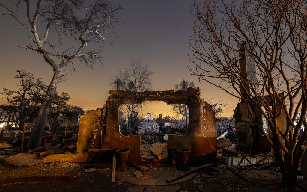 Homes that were destroyed in the Eaton Fire are seen at night on January 10, 2025 in Altadena, California