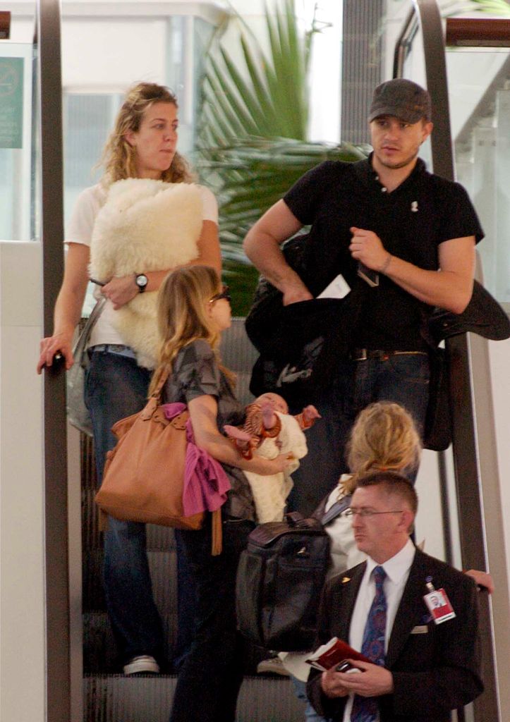 Heath Ledger with Michelle Williams and daughter Matilda Rose Ledger leave Sydney International Airport for their New York home on January 14, 2006 in Sydney, Australia