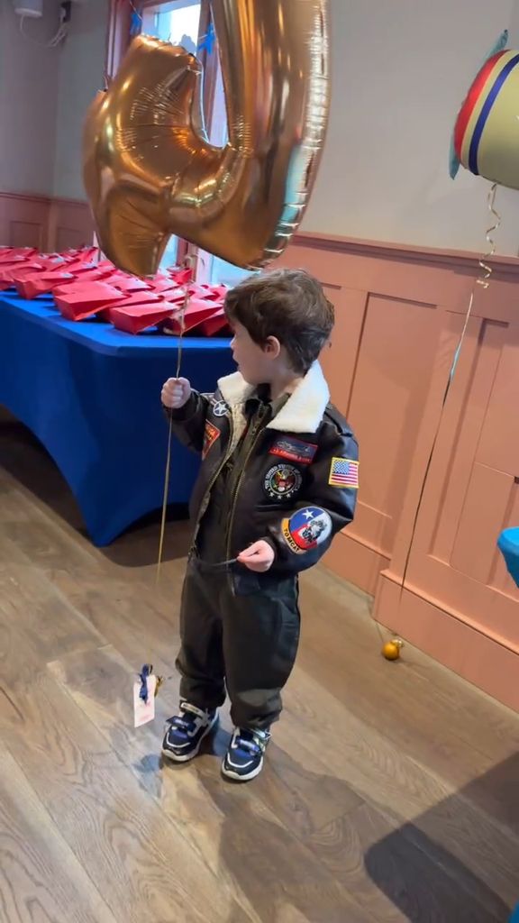 August Brooksbank holds a number 4 balloon as he appeared to have a party for his fourth birthday