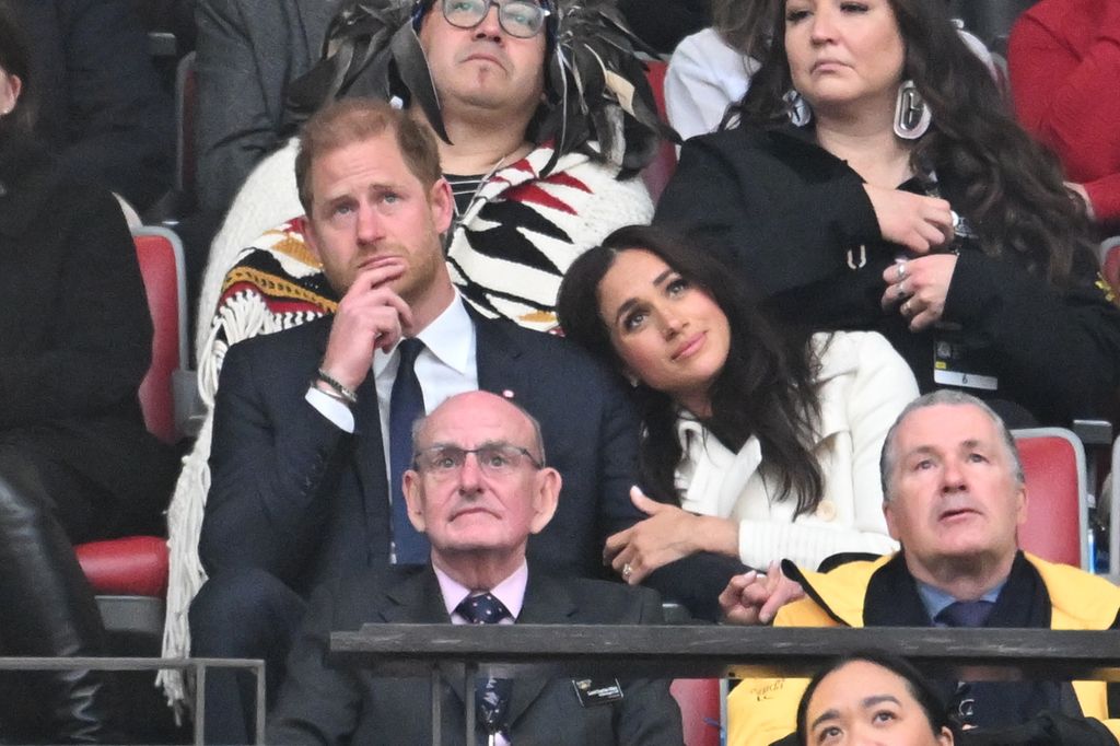 Meghan Markle leaning on Prince Harry