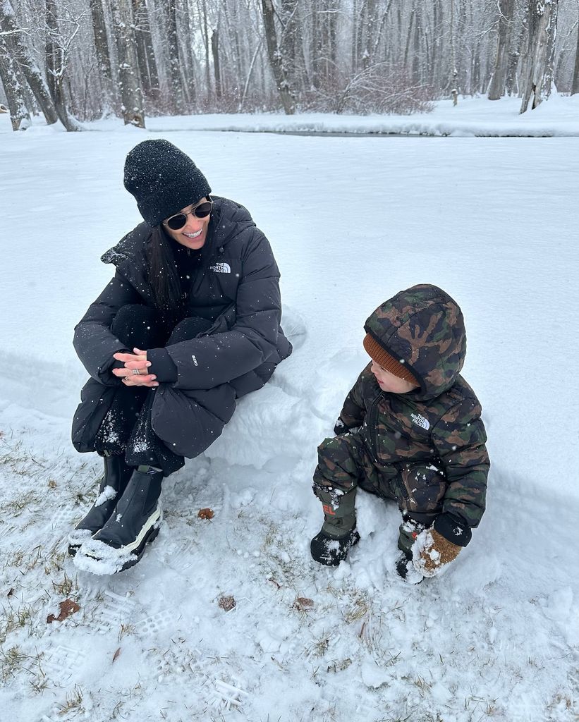 Demi Moore sitting in the snow with her grandson 