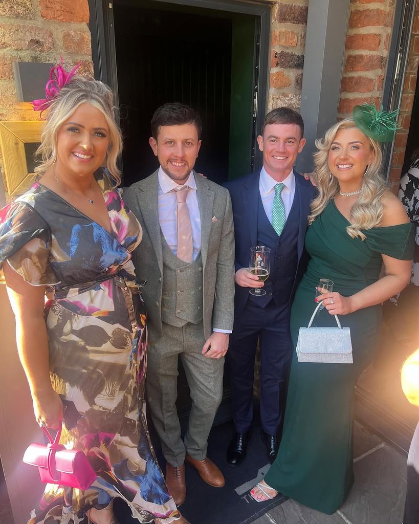 Ellie Warner, her partner Nat, and Izzi Warner with her partner, Toby, posing for a photo at a friends wedding