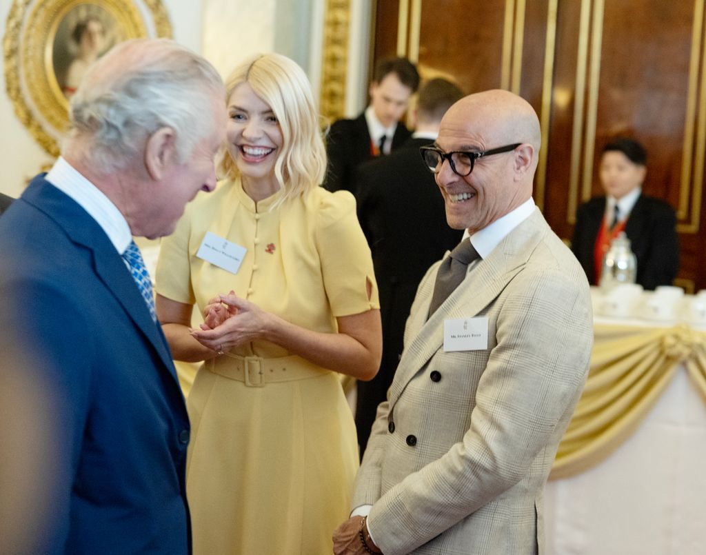 King Charles laughing with Holly Willoughby and Stanley Tucci