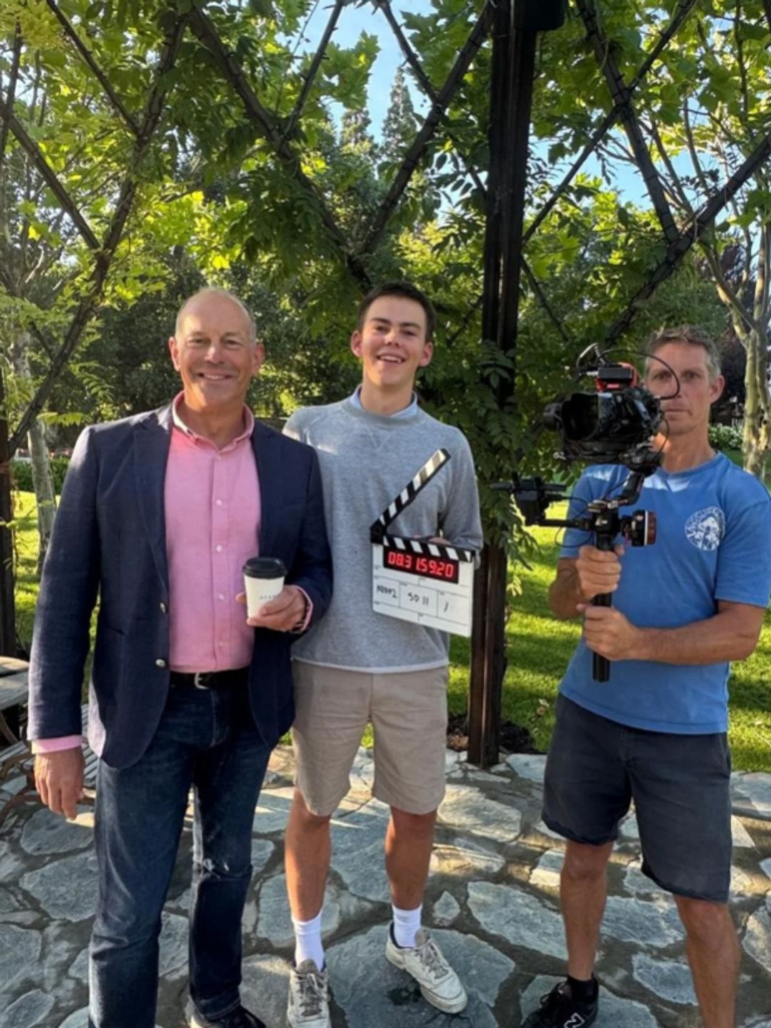 Phil Spencer, his son and a cameraman standing together