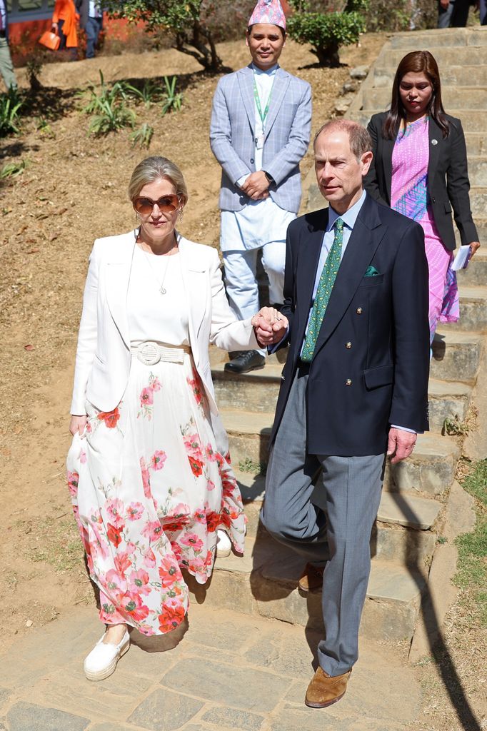 Edward and Sophie hold hands in botanical gardens