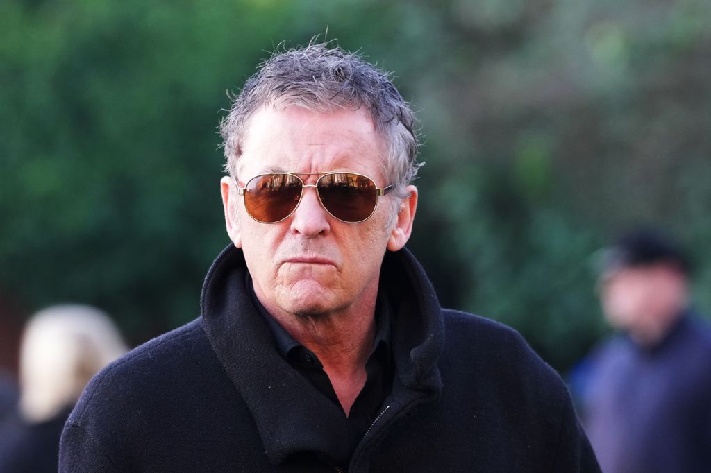 shane Richie in black coat and dark aviators