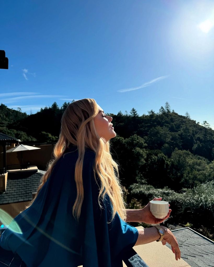 Nicole Kidman meditating outside with morning cup of coffee