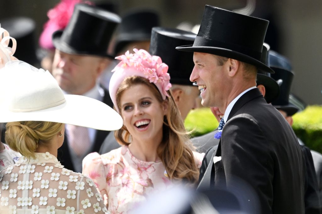 two people laughing and smiling at royal ascot 