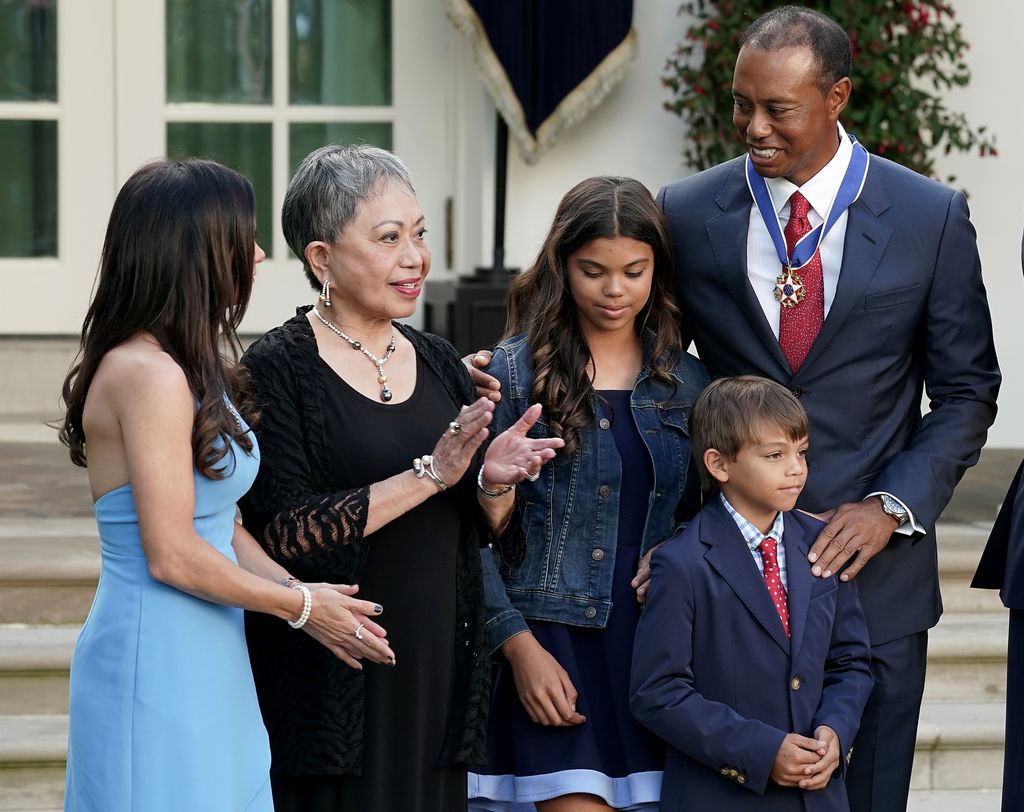 Professional golfer Tiger Woods (R) is joined by his mother Kultida Woods (2nd L), children Sam Alexis Woods and Charlie Axel Woods and girlfriend Erica Herman during his Medal of Freedom ceremony in the Rose Garden at the White House May 06, 2019 in Washington, DC. President Donald Trump announced he would give the nationâs highest civilian honor to business partner Woods, 43, in honor of his Masters victory last month