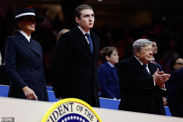 epa11840653 (L-R) First lady Melania Trump, Baron Trump, and Viktor Knavs look on during an indoor inauguration parade at the Capital One Arena in Washington, DC, USA, 20 January 2025. Trump was sworn in for a second term as president of the United States on 20 January. The presidential inauguration was held indoors due to extreme cold temperatures in DC.  EPA/ANNA MONEYMAKER / POOL