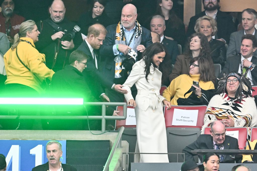 Meghan Markle holding Prince Harry's hand