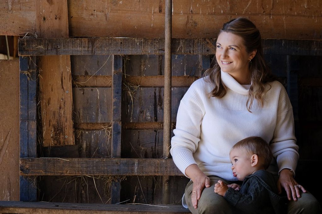 Princess Stephanie in a barn with her son