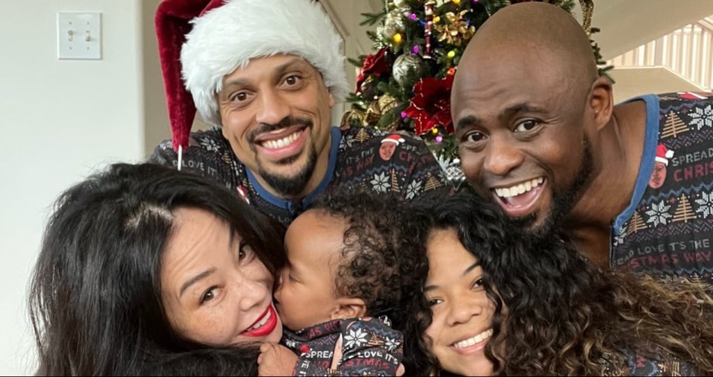 Photo shared by Wayne Brady Christmas 2024 of his blended family, including ex-wife Madie, their daughter, and her partner