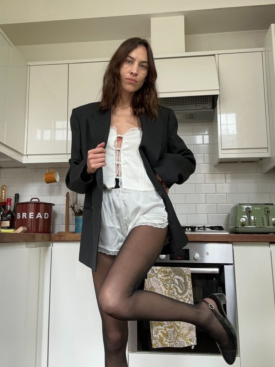 Alexa Chung styles pj's with tights and a blazer 