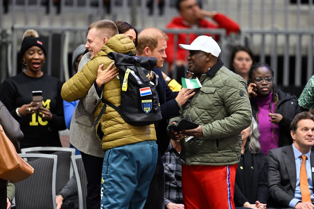 Meghan, Duchess of Sussex is lifted in a bear hug by well wishers during the wheelchair basketball match between the USA v Nigeria during day one of the 2025 Invictus Games at the Vancouver Convention Centre on February 09, 2025 in Vancouver, British Columbia. (Photo by Samir Hussein/WireImage)