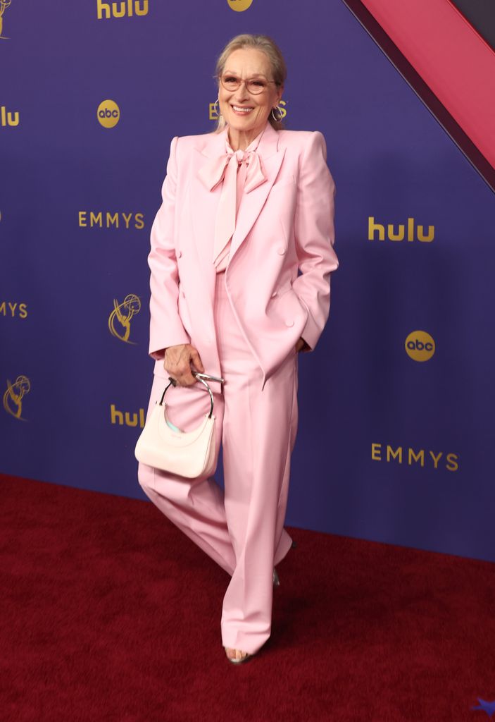 meryl streep on red carpet in pink suit