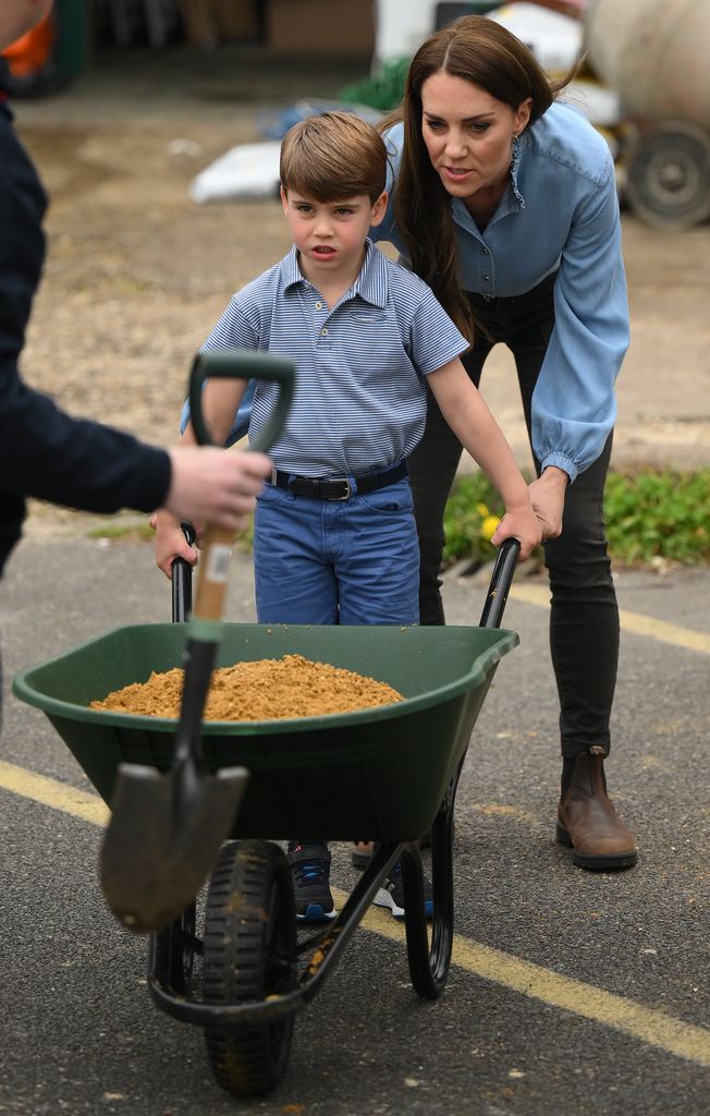 mother and son using wheelbarrow 